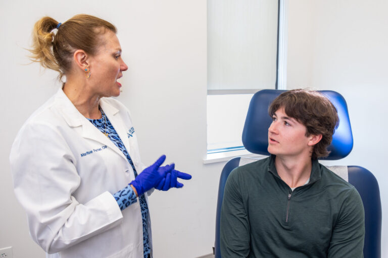 Dermatologist meets with teenage patient to address skin concerns