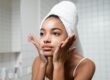Young woman washing her face