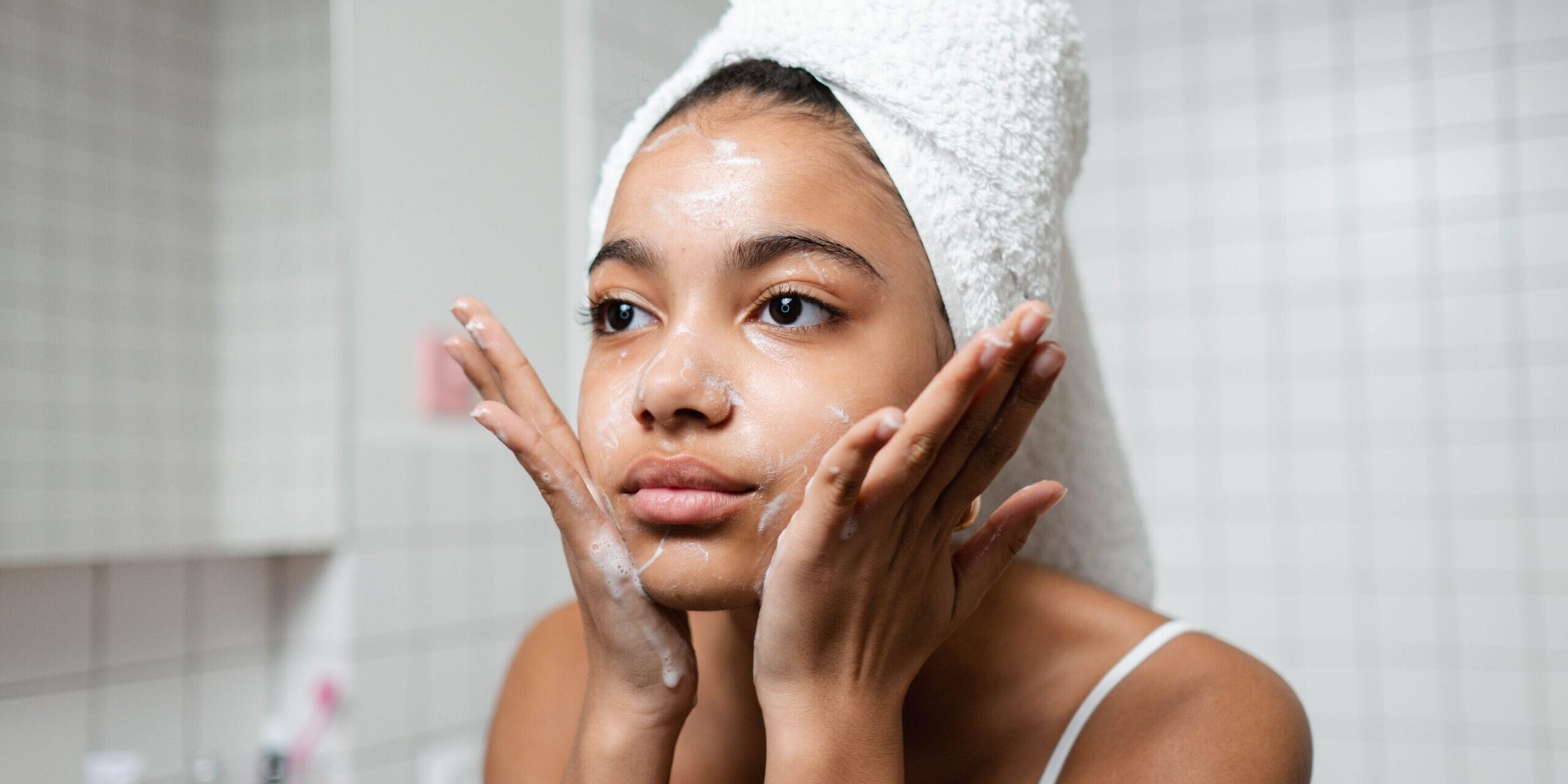 Young woman washing her face