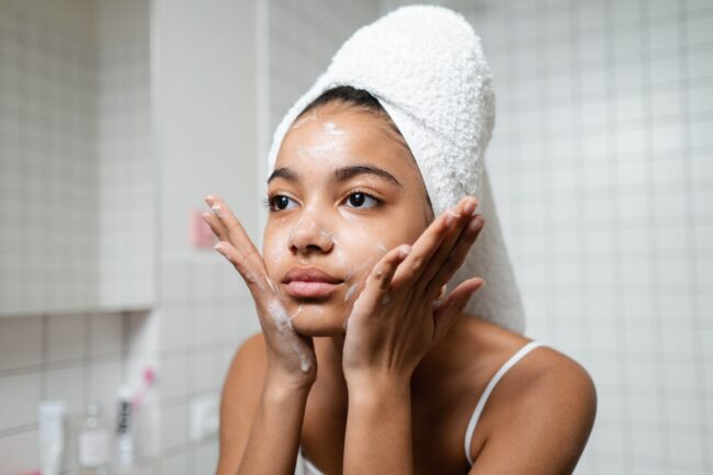 Young woman washing her face