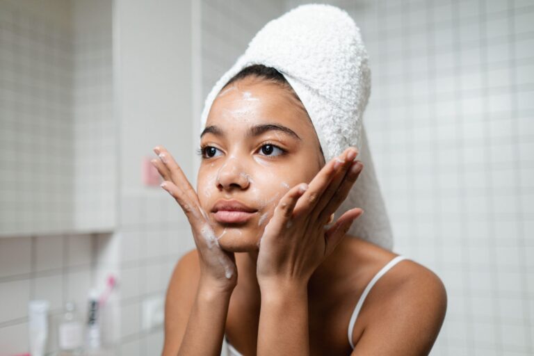 Young woman washing her face
