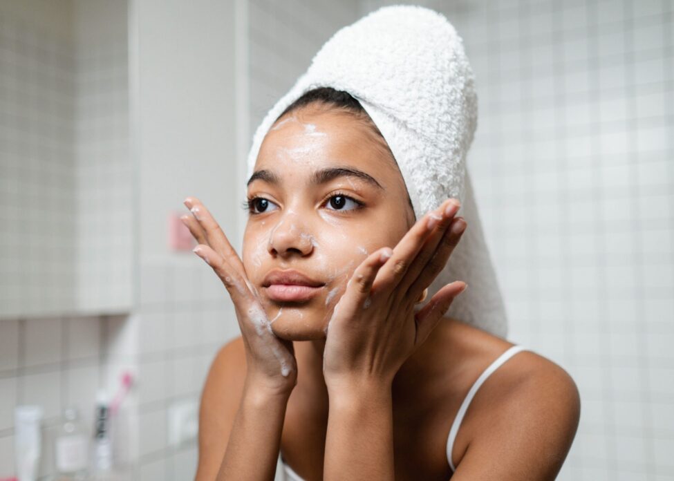 Summer skincare routine Young woman washing her face